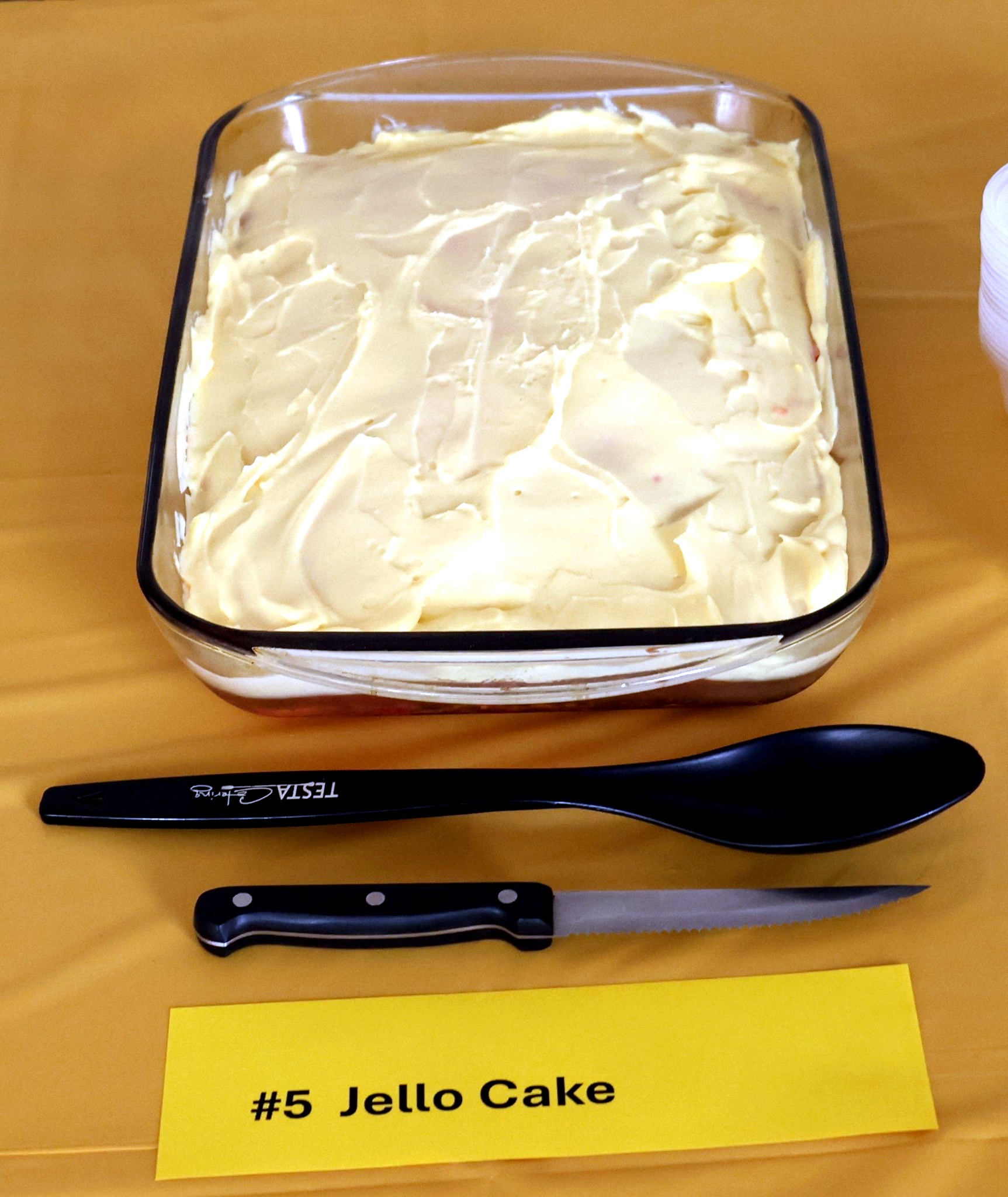 Image of jello cake on a yellow tablecloth
